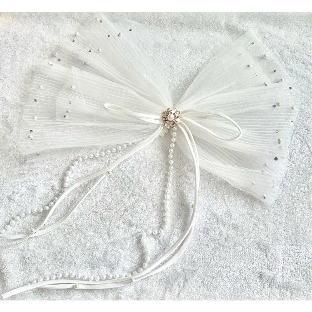 White sheer pleated bow with rhinestone and pearl embellishment